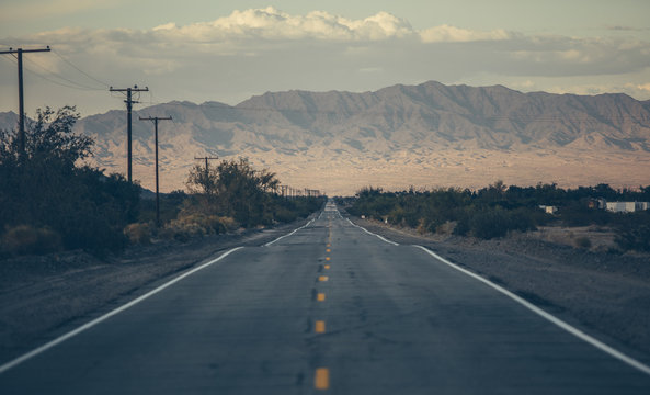 View of empty road against mountain range