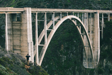 Rear view of man looking at Bixby Creek Bridge