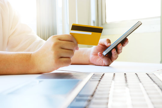 Woman using mobile phone to shopping online and pay by credit card.