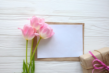 Wooden white background,letter and  tulips.  March 8, Mother's Day.