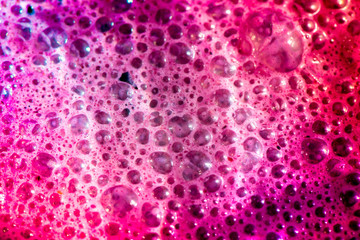 Macro shot of bright and vibrant bubbles in an ice cream cocktail glass

