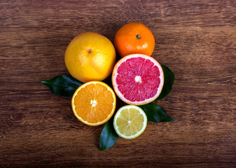  citrus fruit (slice lemon, slice orange, slice grapefruit and tangerine) with leaves  