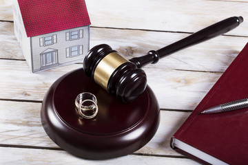 Family law concept, gavel, house and rings 
