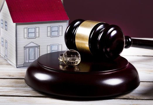Family law concept, gavel, house and rings 