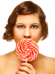 Pretty young woman holding lolly pop. 