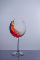 splash of red wine in a glass