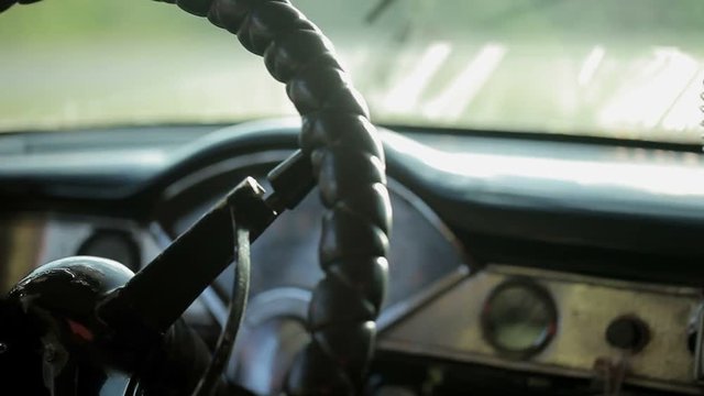 Steering wheel in old car driving closeup