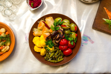 Pickled cucumbers and tomatoes on a plate. Beautiful and tasty food on a plate