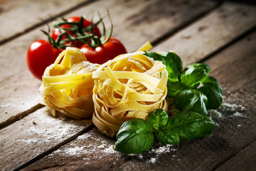 Tasty Fresh Colorful Ingredients for Cooking Pasta Tagliatelle with Fresh Basil and Tomatoes....