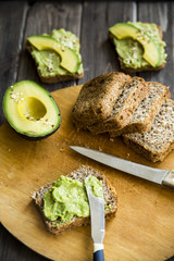 spread with a knife on a paste of avocado bread Greceanii. raw and healthy food for vegan