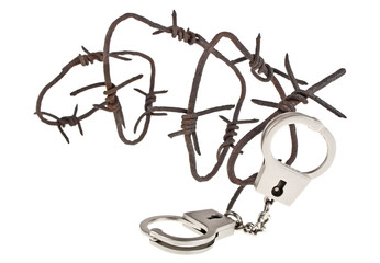 Rusty barbed wire and handcuffs on a white background