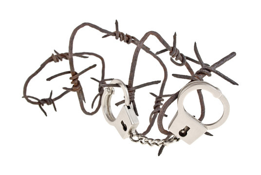 Rusty barbed wire and handcuffs on a white background