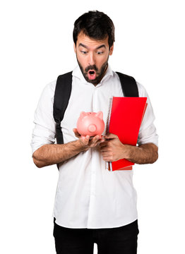 Student man holding a piggybank