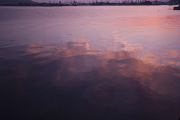 Fototapeta premium Red sunset over the port with water reflections