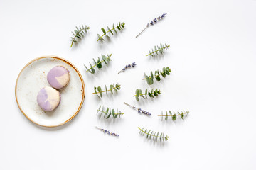 light breakfast with macaroons on spring pattern white background top view