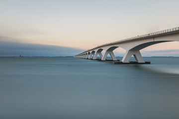 Long exposure photo of Zeeland bridge at sunset