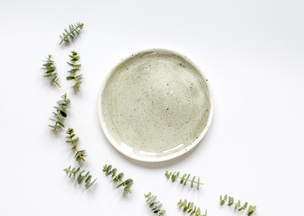 Spring design with plate and eucalyptus on white background top view mockup