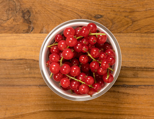 From above view of glass bowl of redcurrant fruit