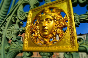 A golden face: detail of the original metal fence of the Royal Palace of Turin, Italy. Tilt-shift effect applied.