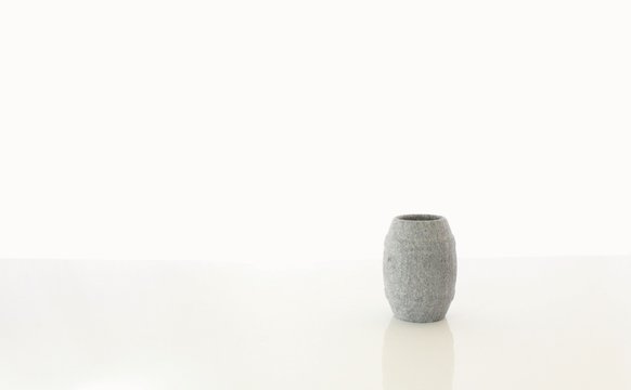Sauna Stone Shot Glass Cup with a White Blurred Background