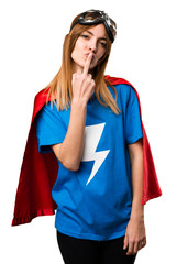 Pretty superhero girl making horn and kiss gesture