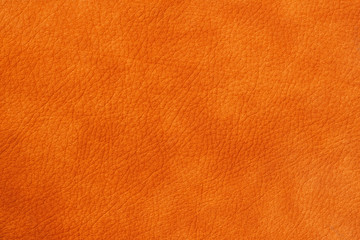 Texture of genuine leather close-up, cowhide, orange. For natural, artisan backgrounds, substrate...