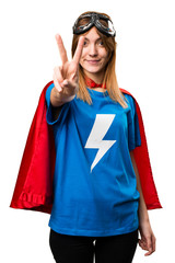 Pretty superhero girl counting two