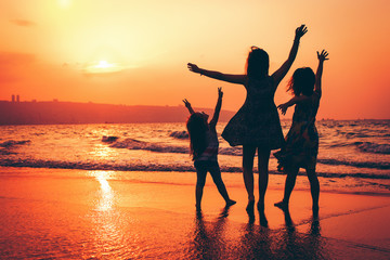 Fototapeta premium Sunset in Israel, happy sisters at the beach.