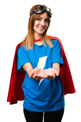 Pretty superhero girl holding something