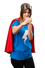 Pretty superhero girl giving a punch