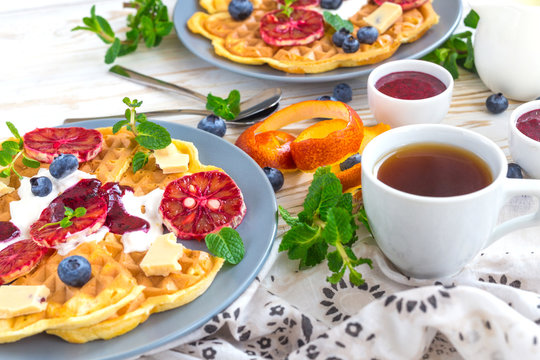 Coffee and Belgium waffles with blueberry. Breakfast concept.