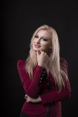Fototapeta premium Smiling woman with lush blonde hair dressed in blouse