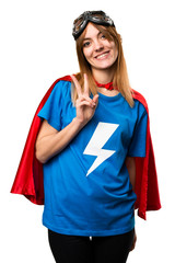 Pretty superhero girl making victory gesture