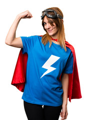 Pretty superhero girl making strong gesture