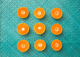 mandarin orange halves on a teal background