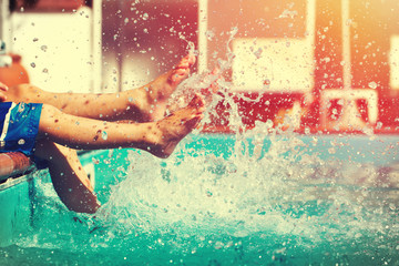 Boys legs splashing water in pool vintage