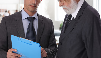 Business meeting success and teamwork concept. Young and mature businessmen together working on project