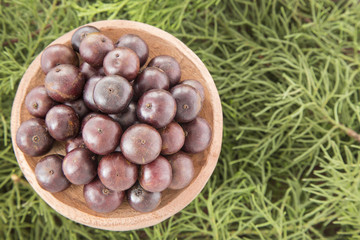 Jaboticaba in the wooden bowl (Plinia cauliflora)