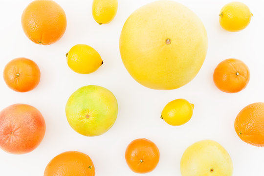 Fruit's background. Citrus fruits - lemon, orange, grapefruit, sweetie and pomelo isolated on white background. Flat lay, top view.