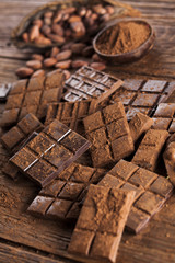 Chocolate bar, candy sweet, dessert food on wooden background