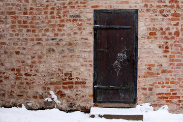 old brick wall with door
