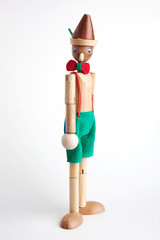 Wooden Pinocchio doll isolated on white background.