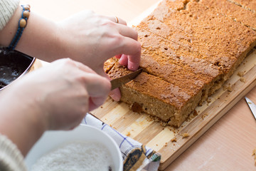 Female hands cutting and preparing cake crust