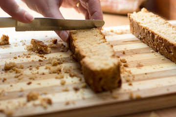 Female hands cutting and preparing cake crust