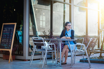 Young woman with smartphone in coffee shop