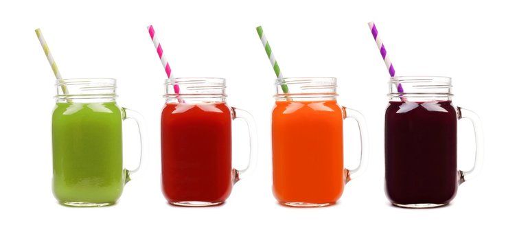 Four mason jar glasses of vegetable juice, greens, tomato, carrot and beet, isolated on a white background