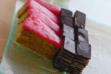 Colorful and delicious chocolate home made small cakes arranged on glass plate