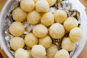 Home made raffaello coconut candy balls in ceramic bowl