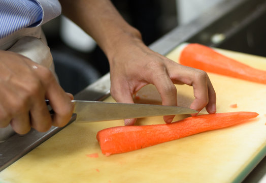 Chef cutting carrot prepare food in restaurant,Hand cutting vegetable fast it's skill