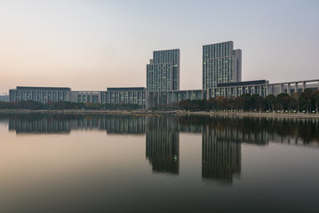 Fototapeta na wymiar buildings standing by riverside under dramatic sky,wuxi city,jiangsu province,China.